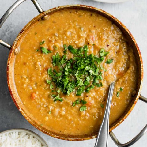 masoor tadka dal served garnished with cilantro and a side of basmati rice and chapati