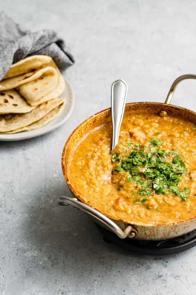 cooked masoor dal tadka served with some chapati