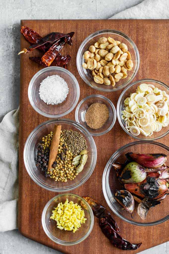 ingredients in massaman curry paste, measured and laid out on a cutting board