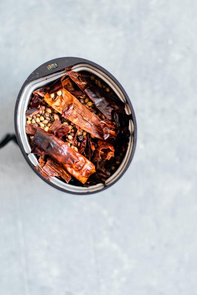 toasted spices for massaman curry in a spice grinder