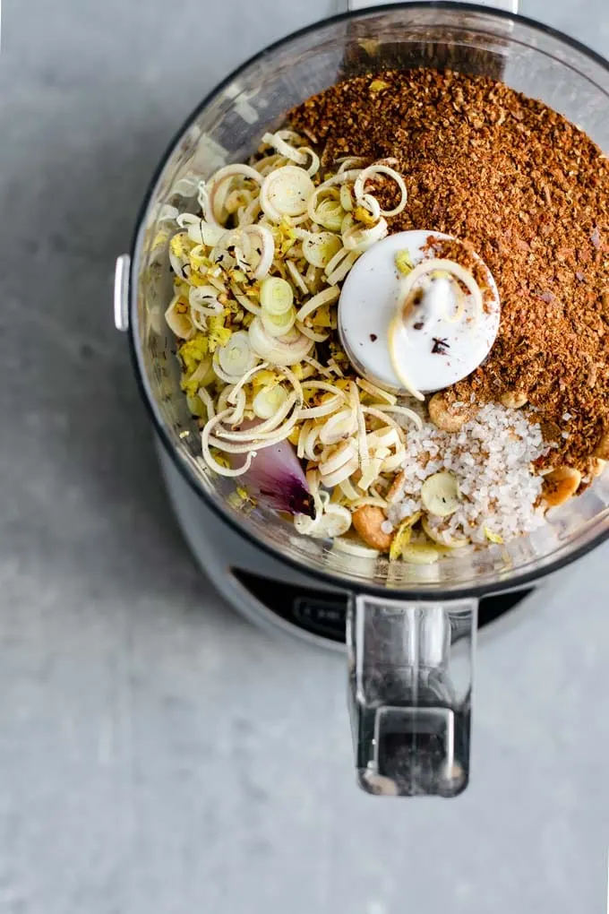 Massaman curry paste ingredients prepared and in a food processor to process to a paste