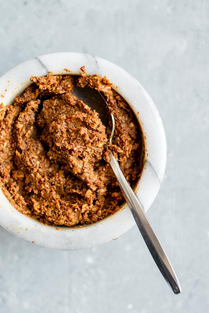 massaman curry paste, prepared and in a white bowl with a spoon in it.