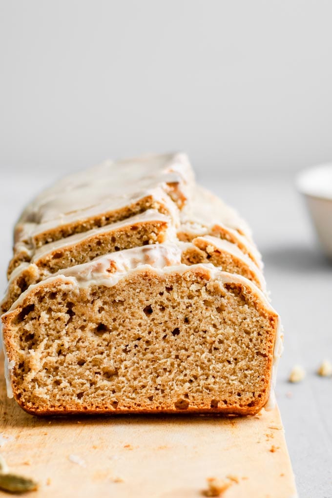 straight on shot of sliced vegan chai spice cake showing the soft texture of the loaf