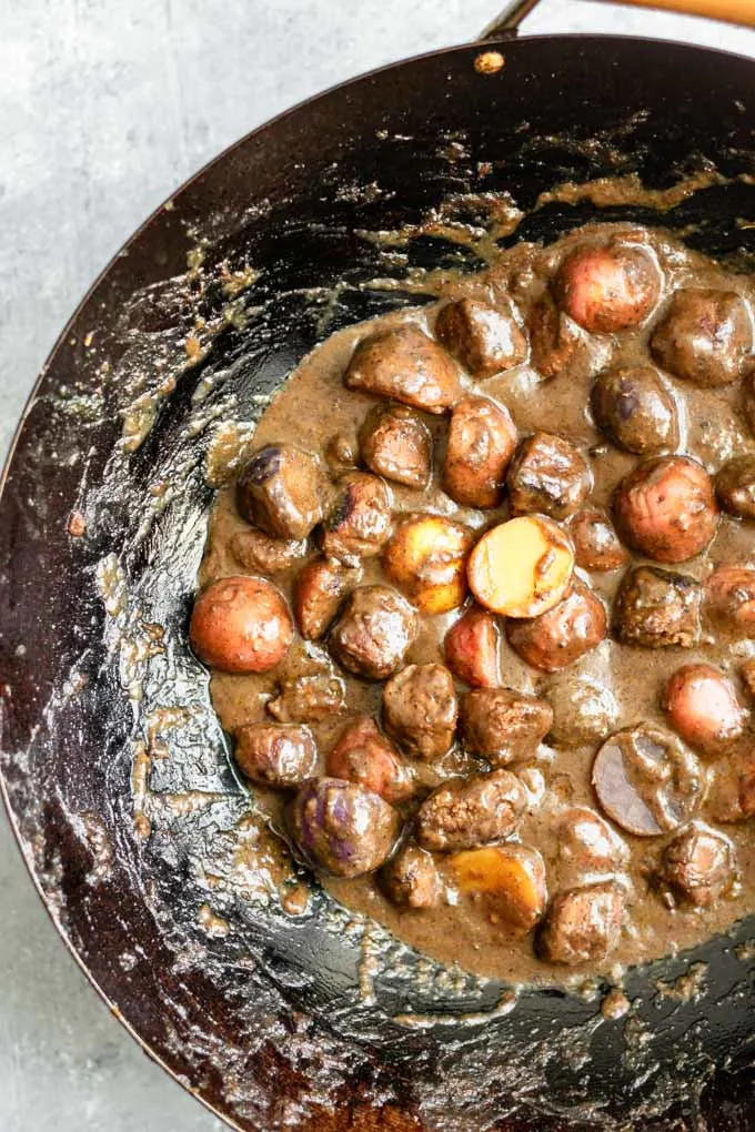 the cooked potatoes and vegan beef in massaman curry in the wok