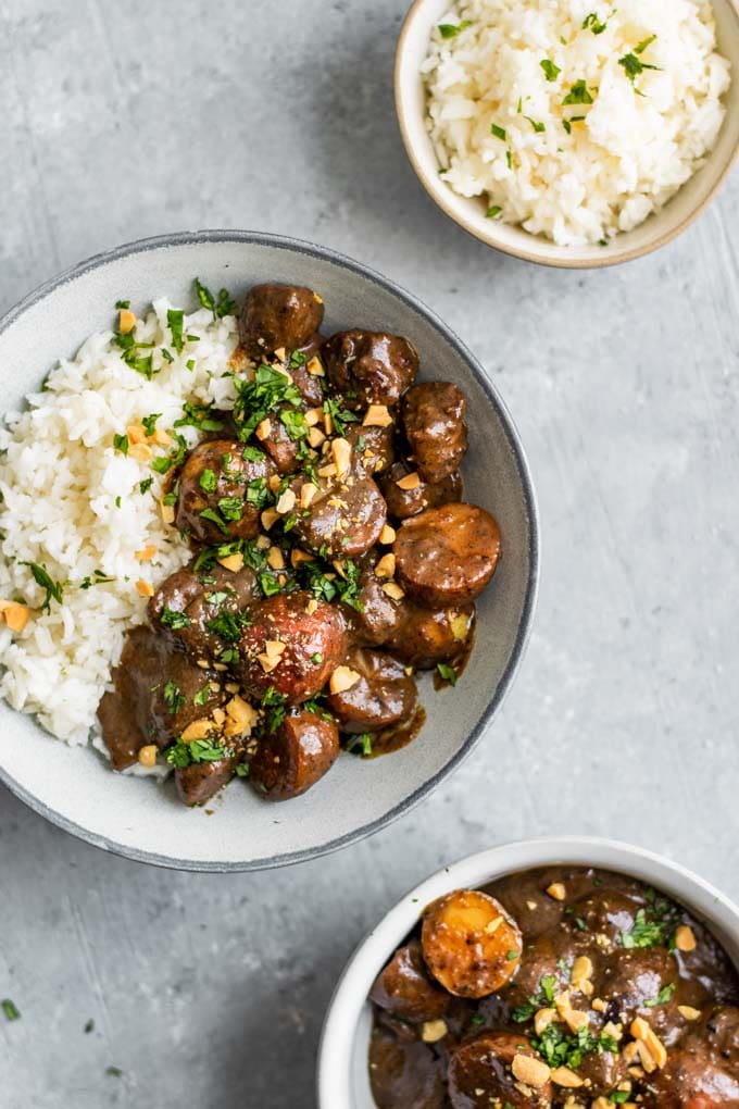 vegan massaman curry served with jasmine rice and garnished with chopped peanuts and cilantro