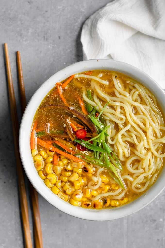 vegan ramen with miso tahini broth, charred corn, and carrots and jalapeño