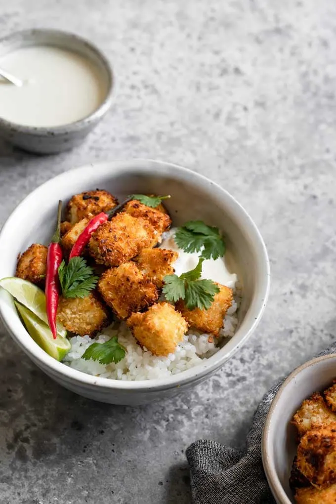 crispy coconut tofu served with sushi rice, cilantro, thai chiles, and wedges of lime and wasabi sauce on the side