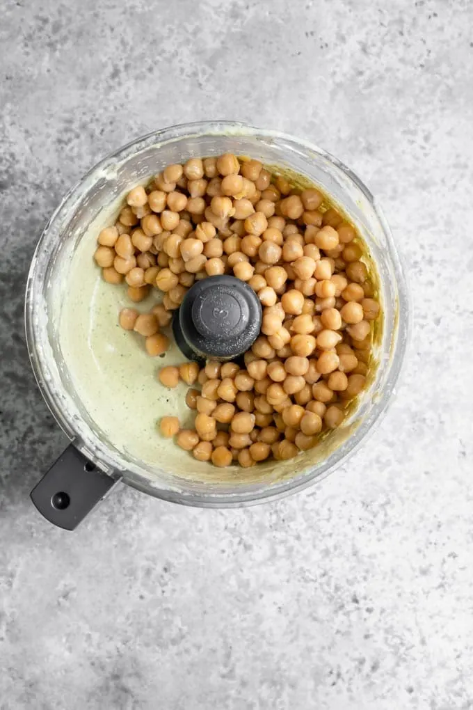 chickpeas added to the tahini emulsion to make hummus