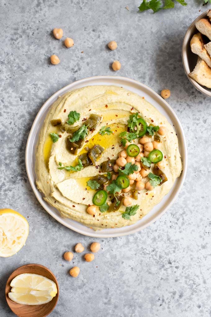 roasted jalapeÃ±o and cilantro hummus topped with chickpeas, roasted jalapeÃ±o and fresh jalapeÃ±o, cilantro, red pepper flakes, and extra virgin olive oil, served with lemon wedges and pita