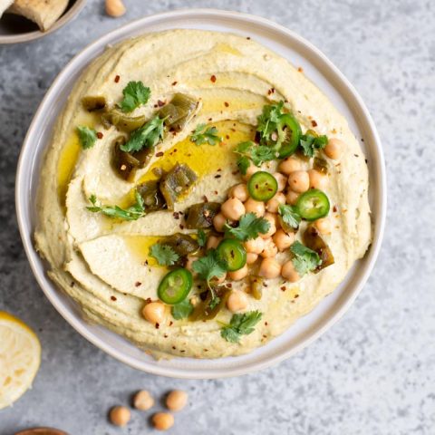 roasted jalapeño and cilantro hummus topped with chickpeas, roasted jalapeño and fresh jalapeño, cilantro, red pepper flakes, and extra virgin olive oil, served with lemon wedges and pita