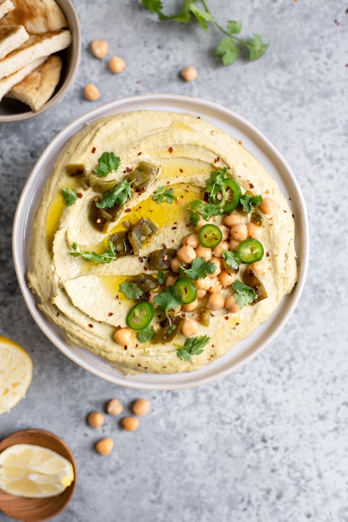 roasted jalapeÃ±o and cilantro hummus topped with chickpeas, roasted jalapeÃ±o and fresh jalapeÃ±o, cilantro, red pepper flakes, and extra virgin olive oil, served with lemon wedges and pita