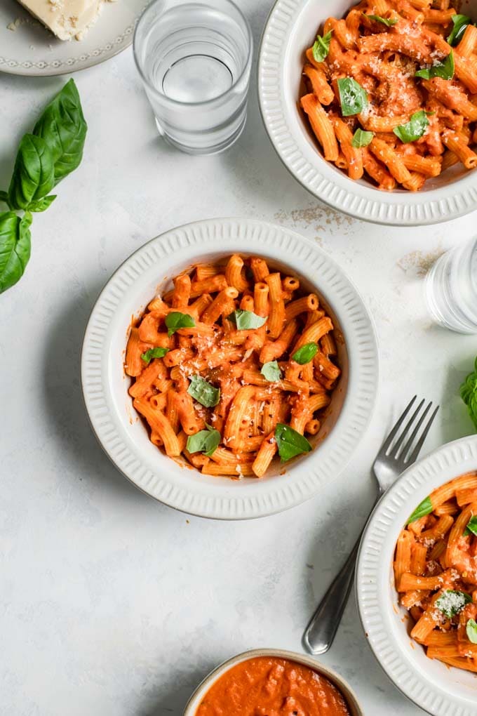 pasta tossed with vegan vodka sauce and garnished with torn basil, vegan parmesan, and some red pepper flakes