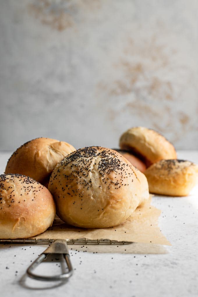 side view of vegan milk bread buns topped with poppy seeds