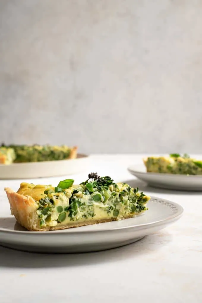 side view of a slice of the sprouting broccoli quiche, showing the texture of the quiche