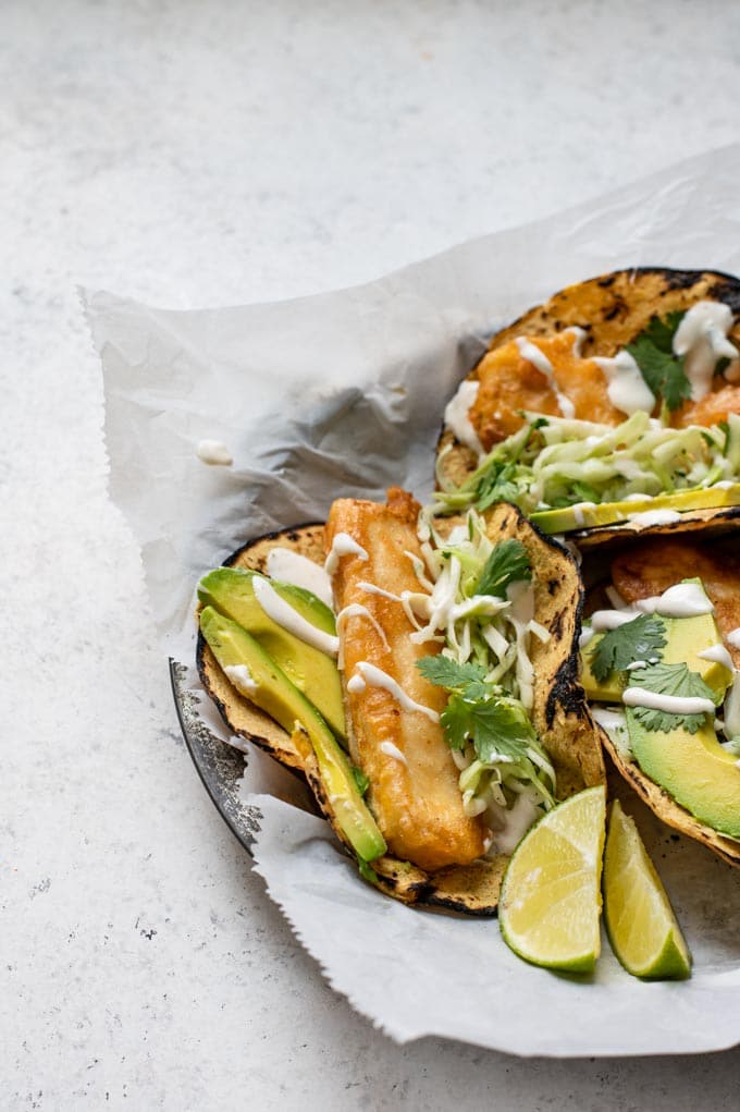 close up showing the tofu cutlet of the Baja tofu tacos on a parchment lined plate