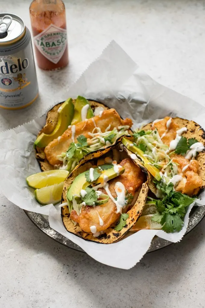 Baja tofu tacos served with a can of beer and some hot sauce