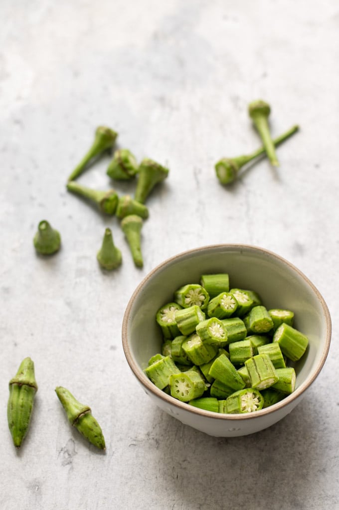 okra cut and trimmed in a bowl, ready to cook