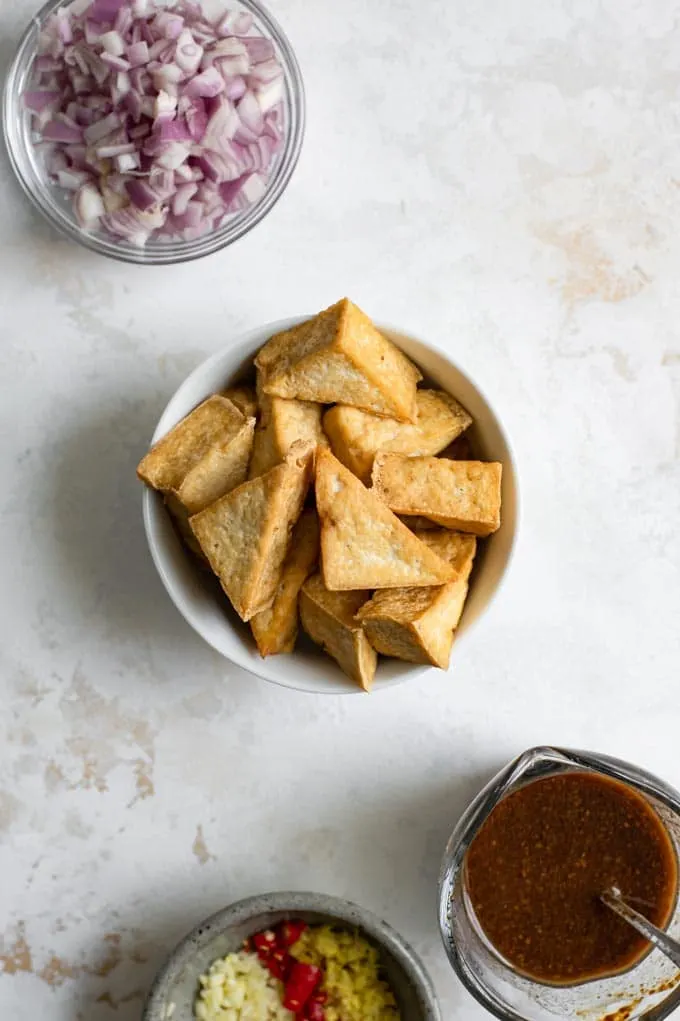 the mise on place of fried tofu, shallots, garlic, ginger, chili, and the black bean sauce