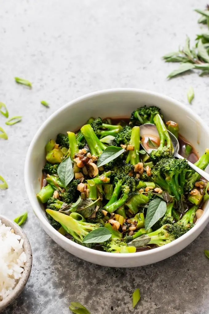 broccoli in garlic sauce garnished with thai basil and scallion greens and served with jasmine rice