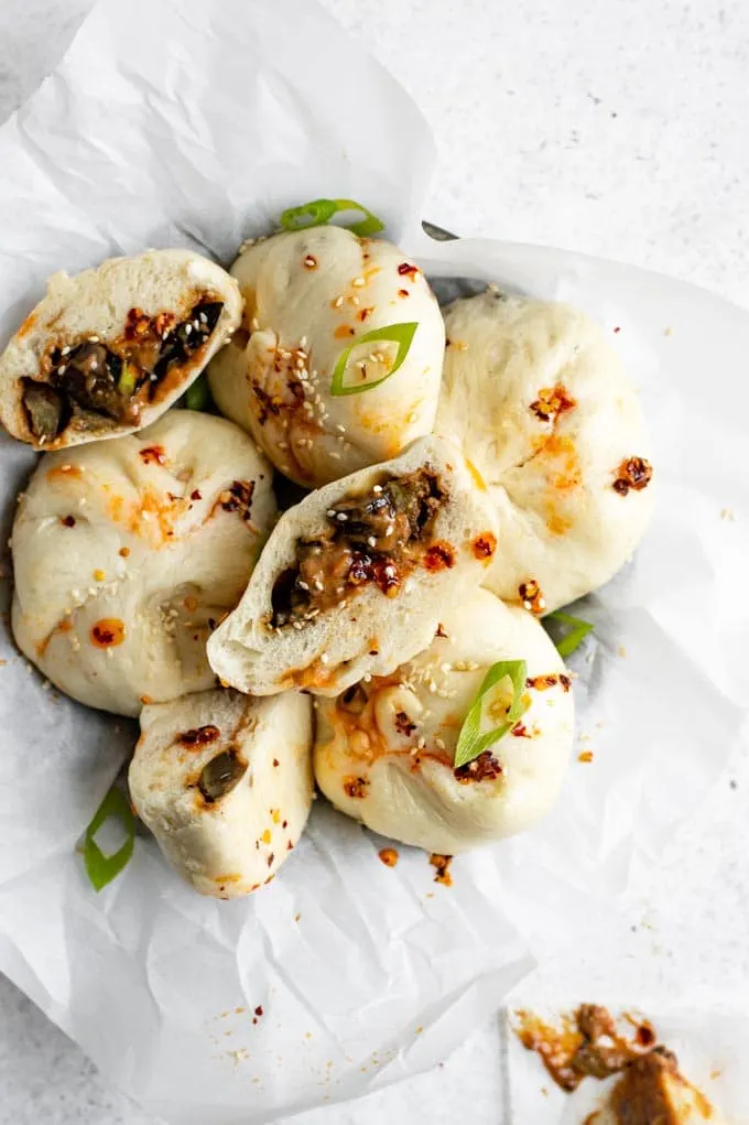 hoisin eggplant bao in a bowl, with one cut open to show the filling