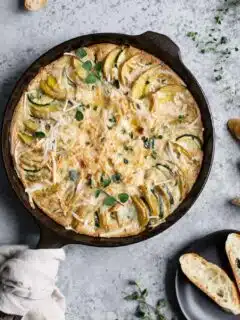 the potato and zucchini gratin just out of the oven, served with sliced baguette