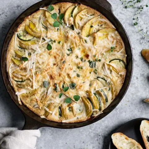 the potato and zucchini gratin just out of the oven, served with sliced baguette