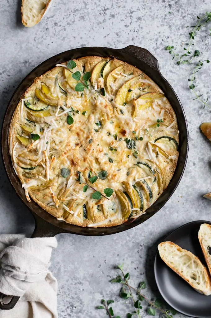 the potato and zucchini gratin just out of the oven, served with sliced baguette