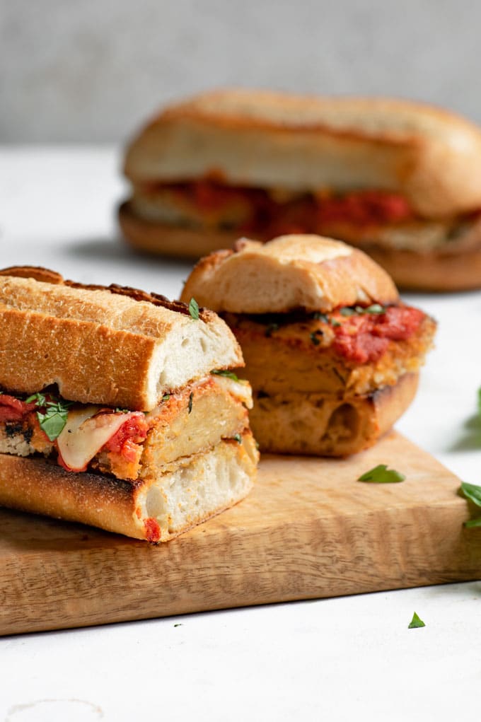 seitan parmesan sandwich shown cut in half to see setain texture