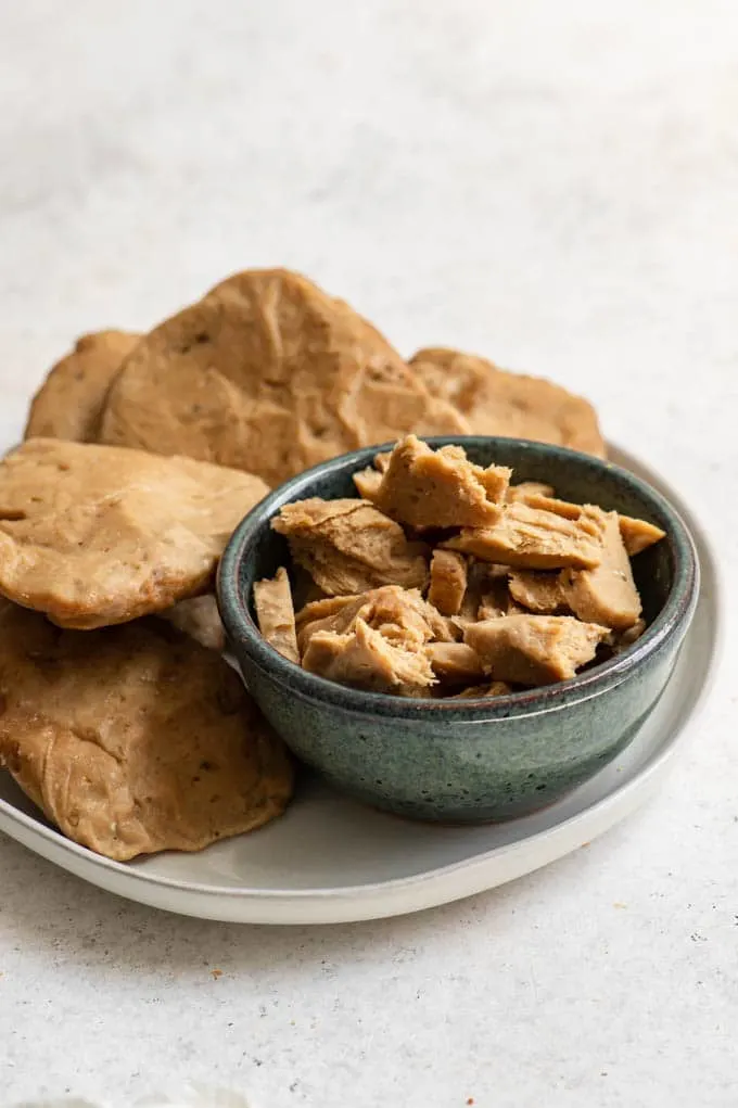 vegan chicken-style seitan in cutlets and some shredded in a bowl