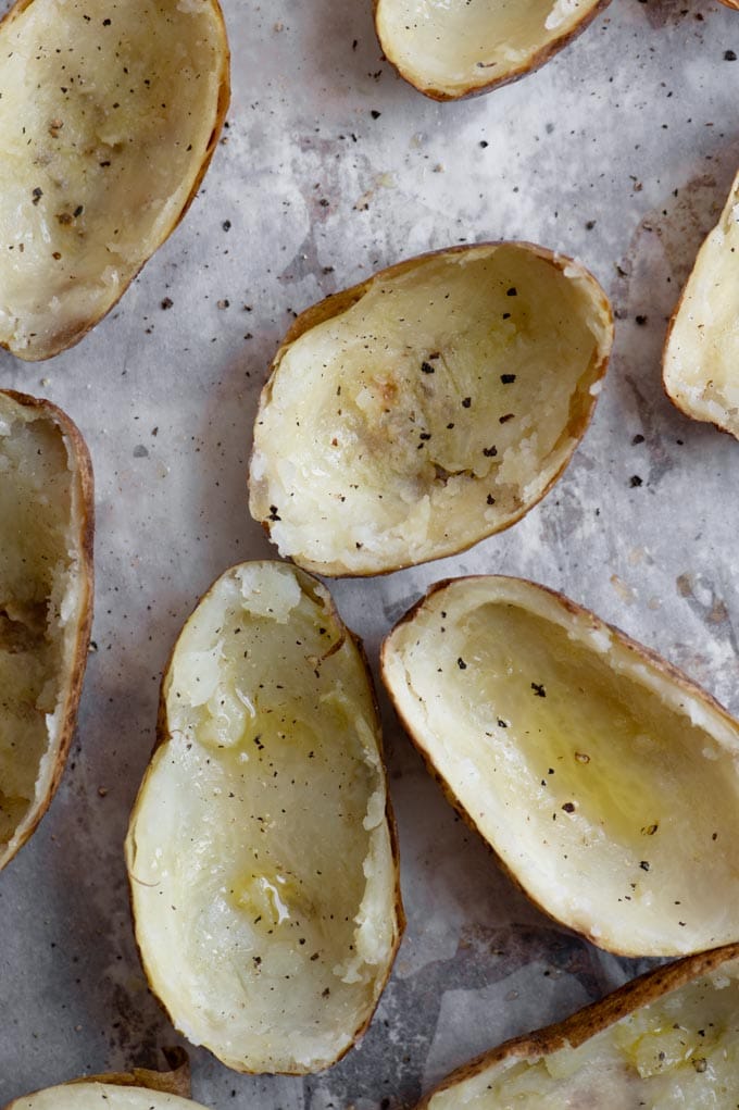 baked potatoes with the insides scooped out, rubbed with olive oil and sprinkled with salt and pepper