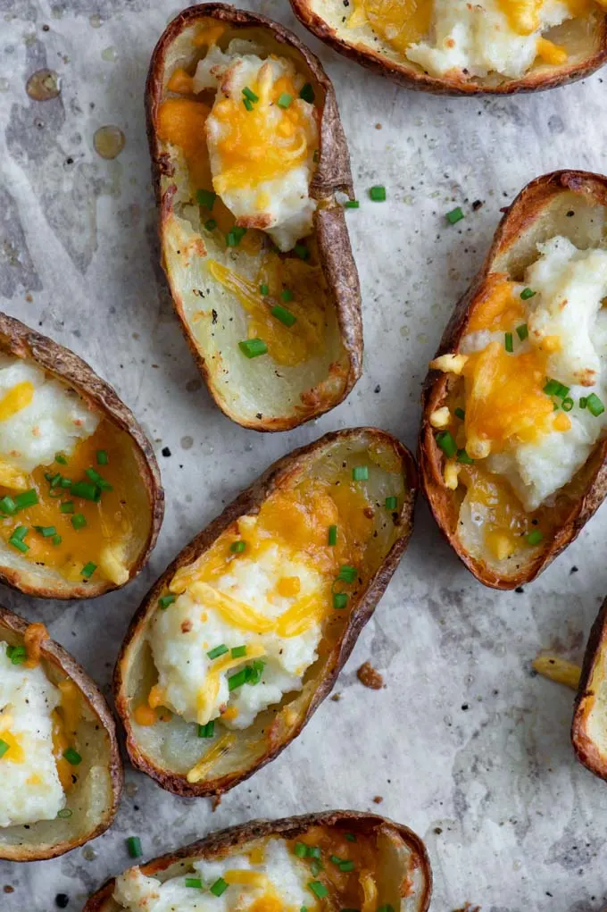 close up of the baked potato skins just out of the oven garnished with chives