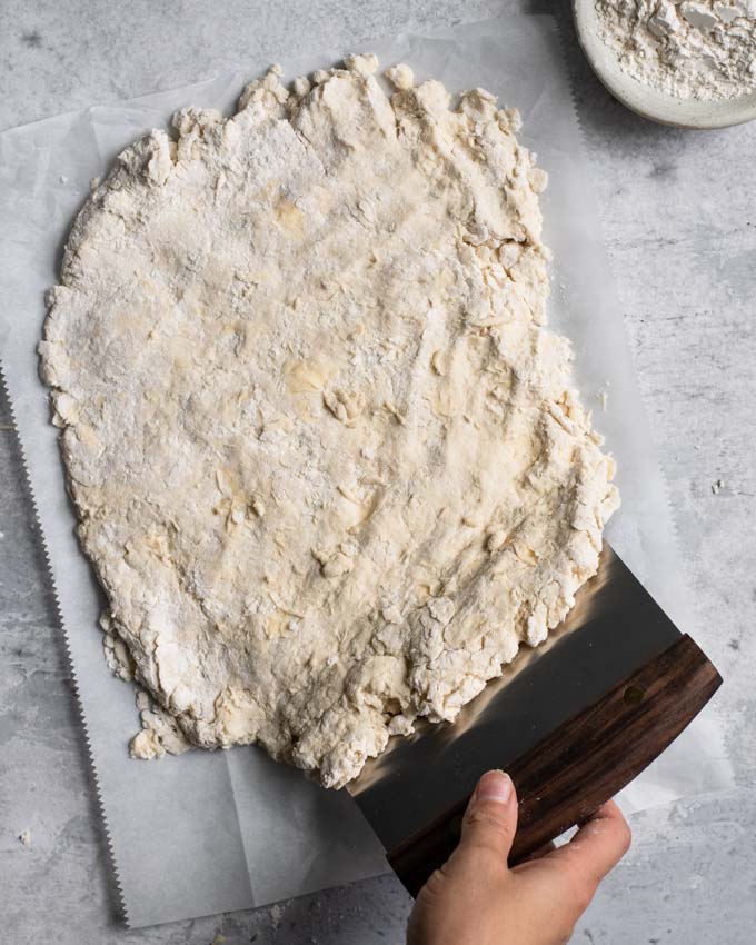 using a bench scraper to assist folding the dough