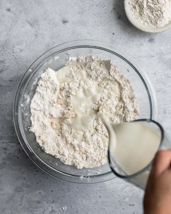 pouring the vegan buttermilk into the dry mixture