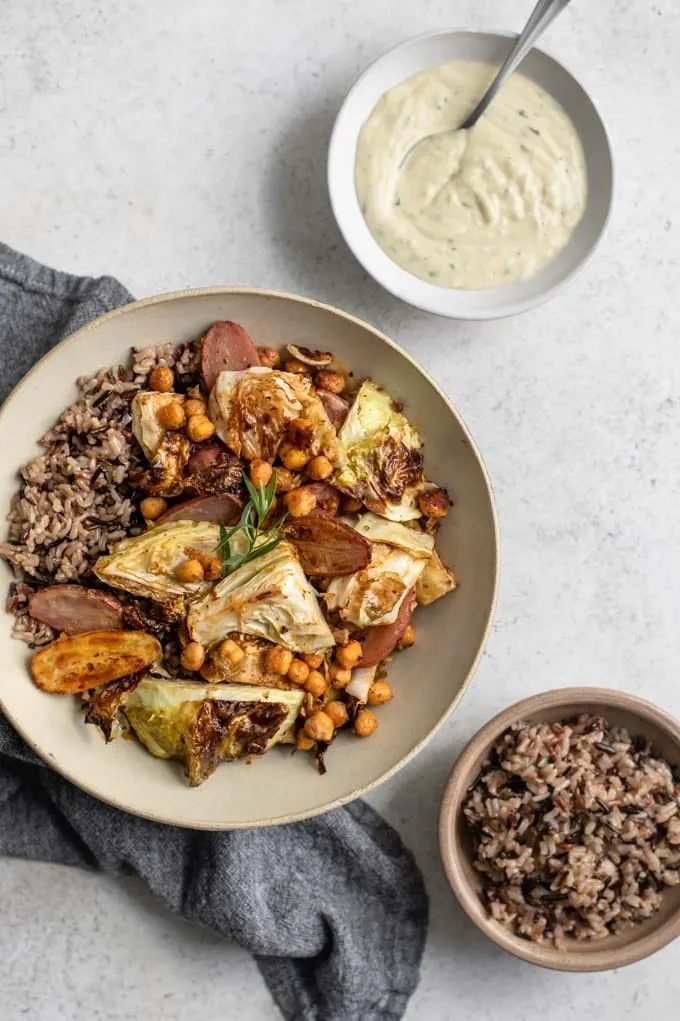 cabbage, potato, and chickpea sheet pan dinner served with wild rice and a side of tarragon gravy