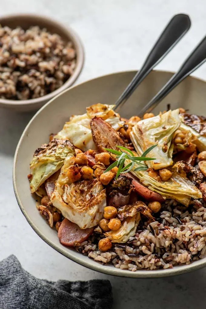 sheet pan dinner in a bowl served with wild rice