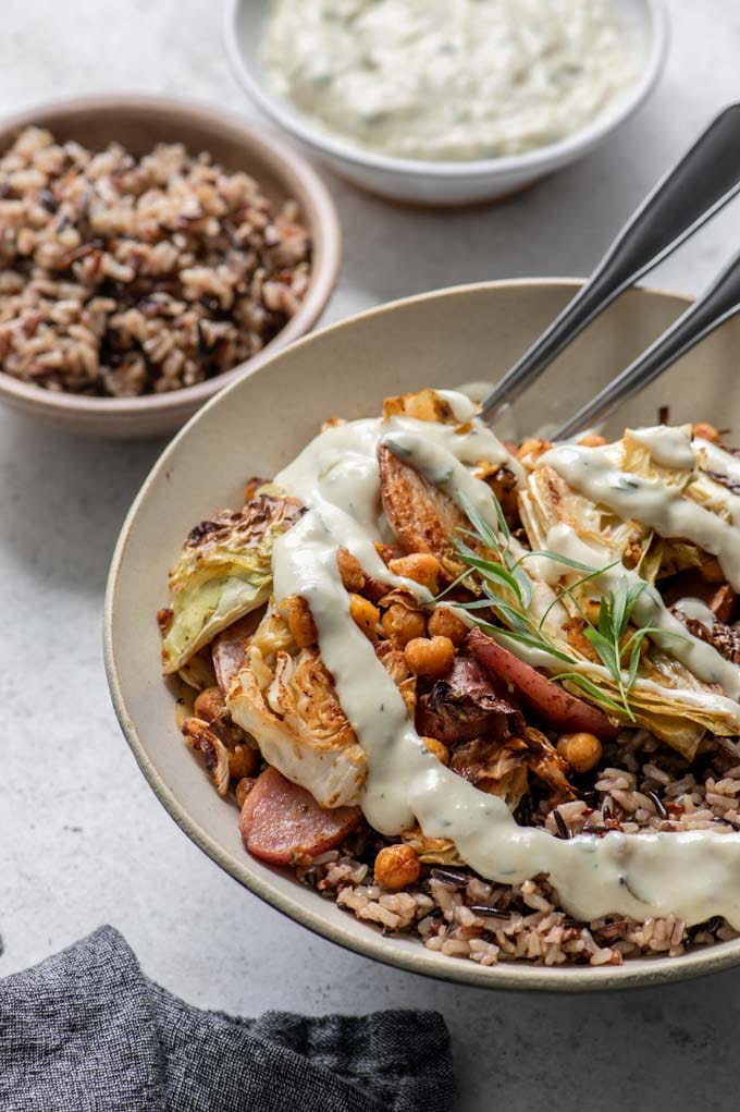 vegan cabbage sheet pan dinner with tarragon cream gravy drizzled overtop