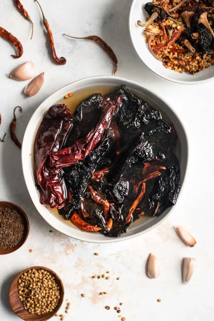 dried chiles soaking in boiling hot water