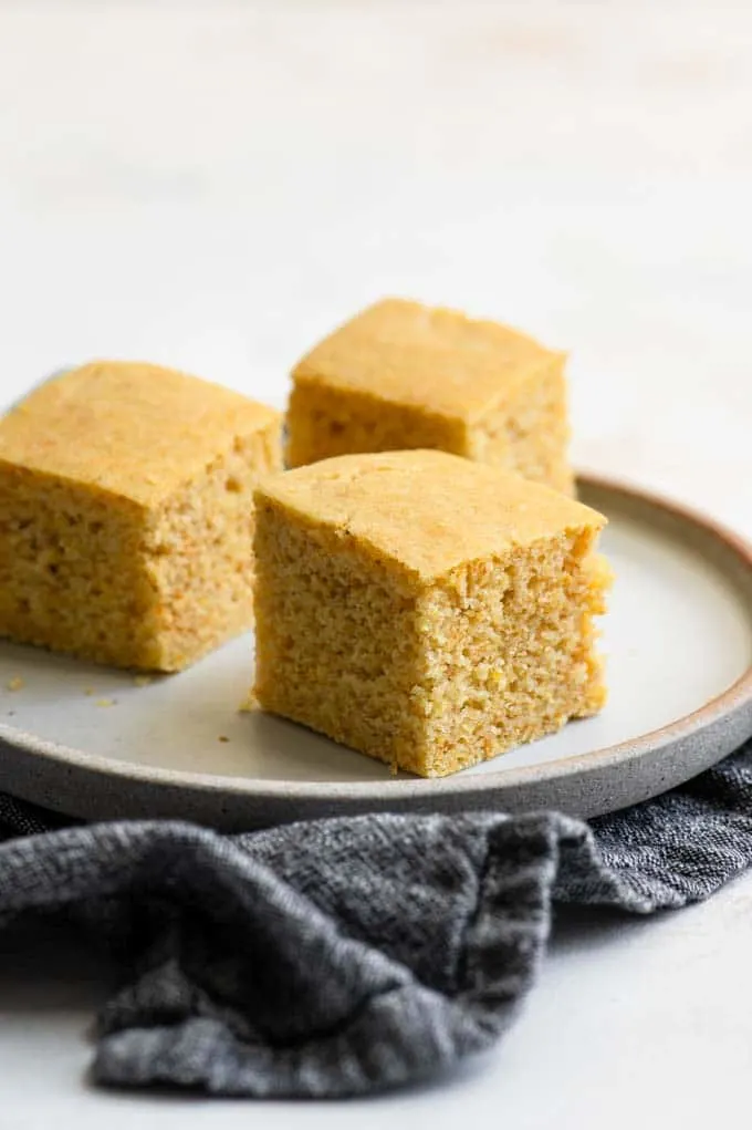 three pieces of cornbread on a plate
