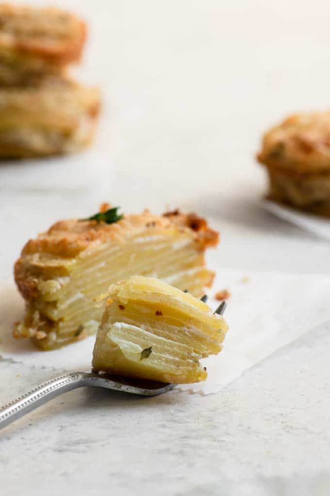 vegan potato stack cut in half, with a bite on a fork