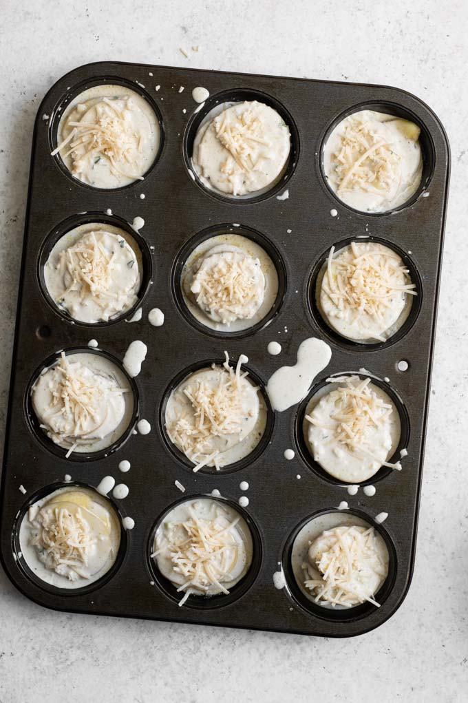 potato stacks assembled in muffin tins ready to bake