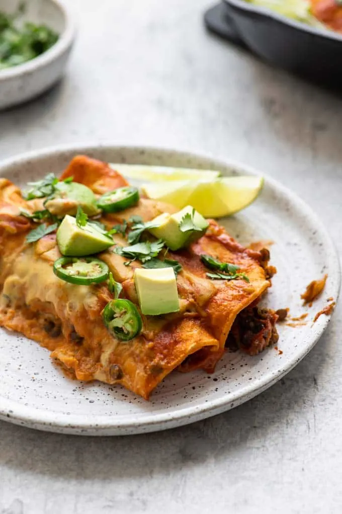 enchiladas on a plate served with lime