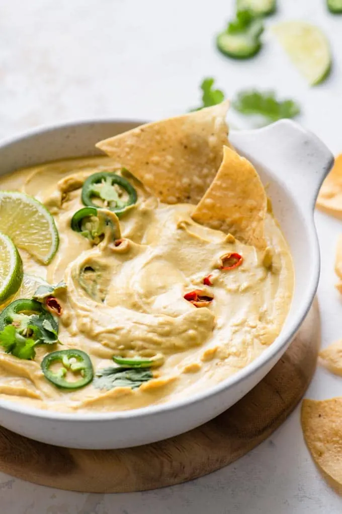 chips dipped into butternut queso