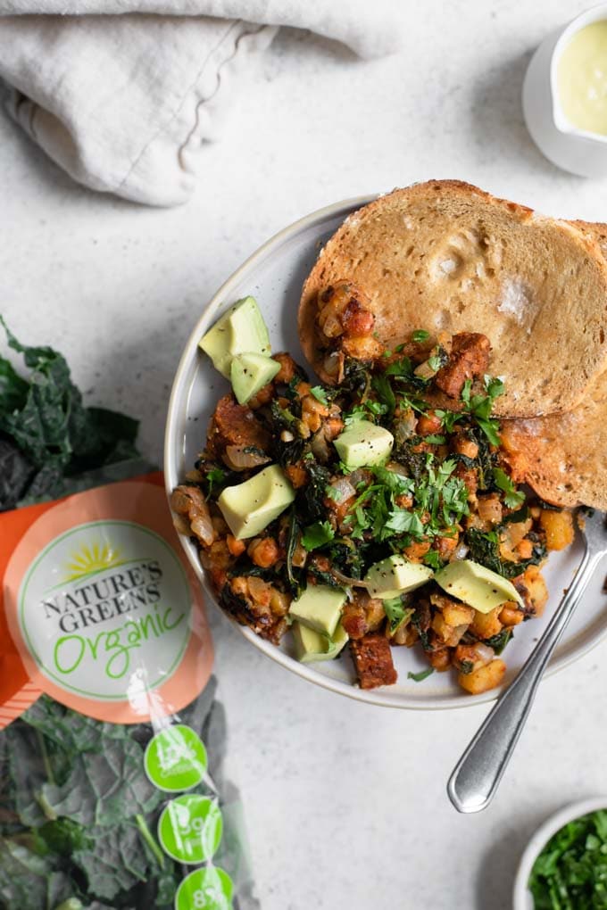 vegan breakfast hash served on a plate with nature's greens kale