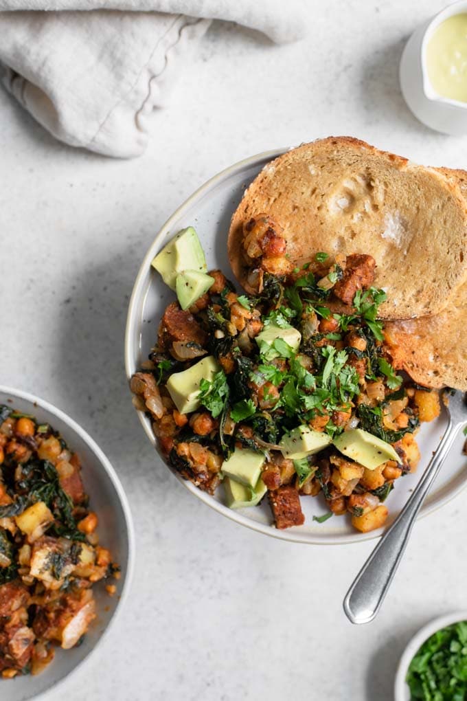 serving of vegan breakfast hash with bread and avocado