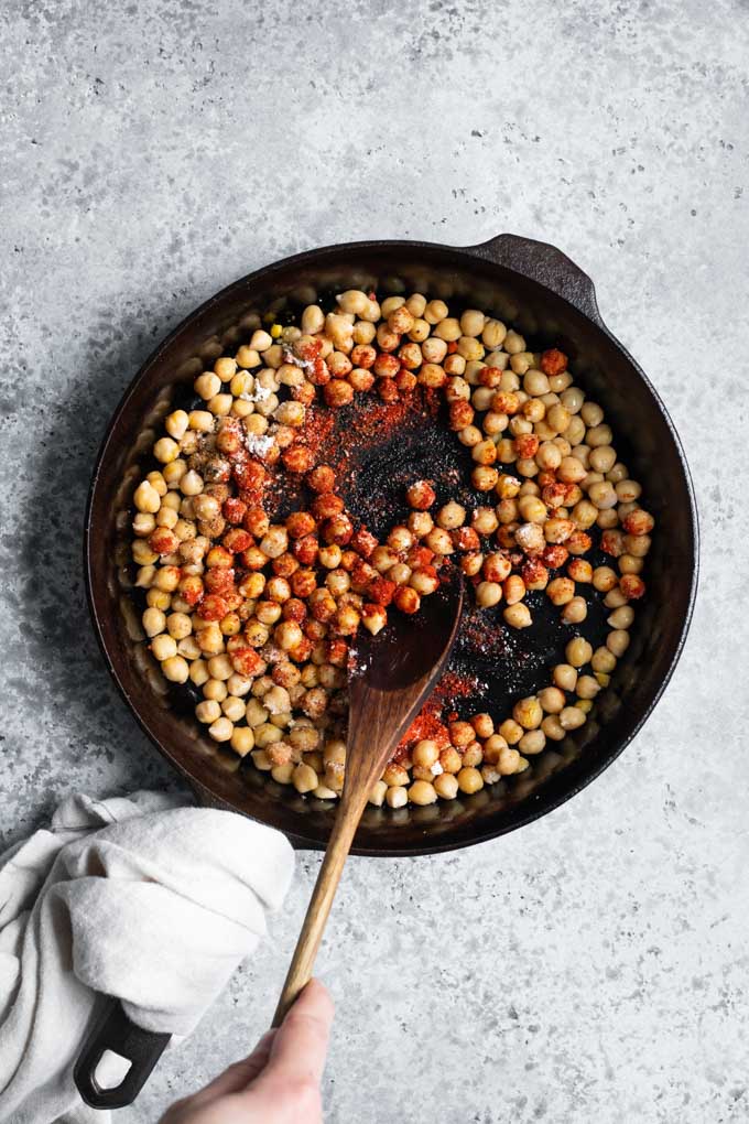 stirring chorizo spices into the chickpeas