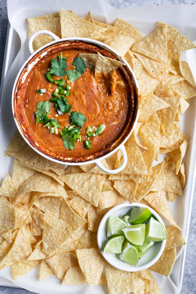 vegan bean dip served with wedges of lime and tortilla chips