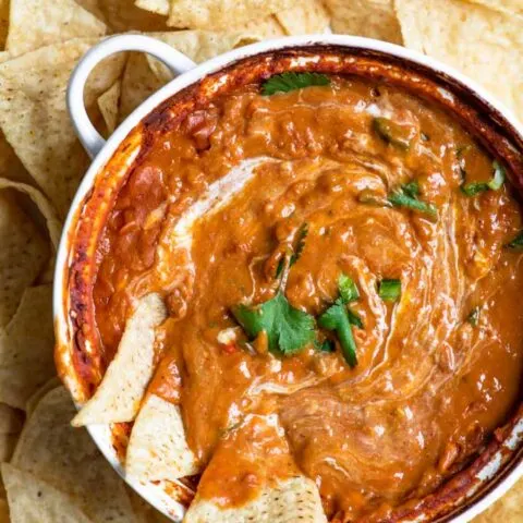 close up of refried bean dip with a sour cream swirl