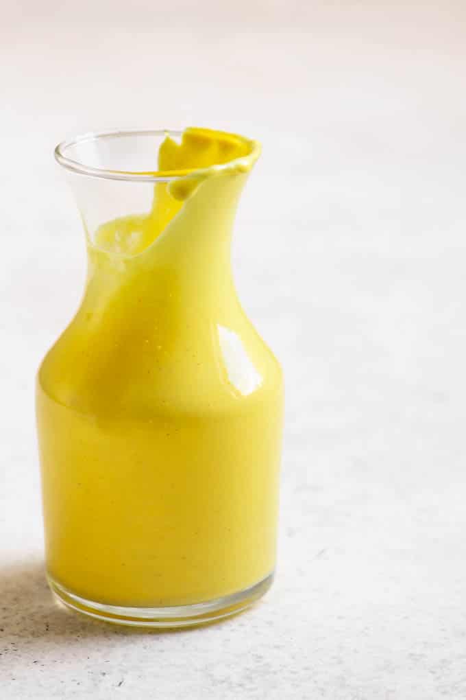 jar of vegan hollandaise, half poured out