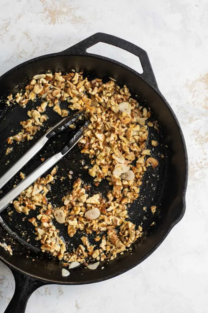 toasting walnuts and garlic in the pan