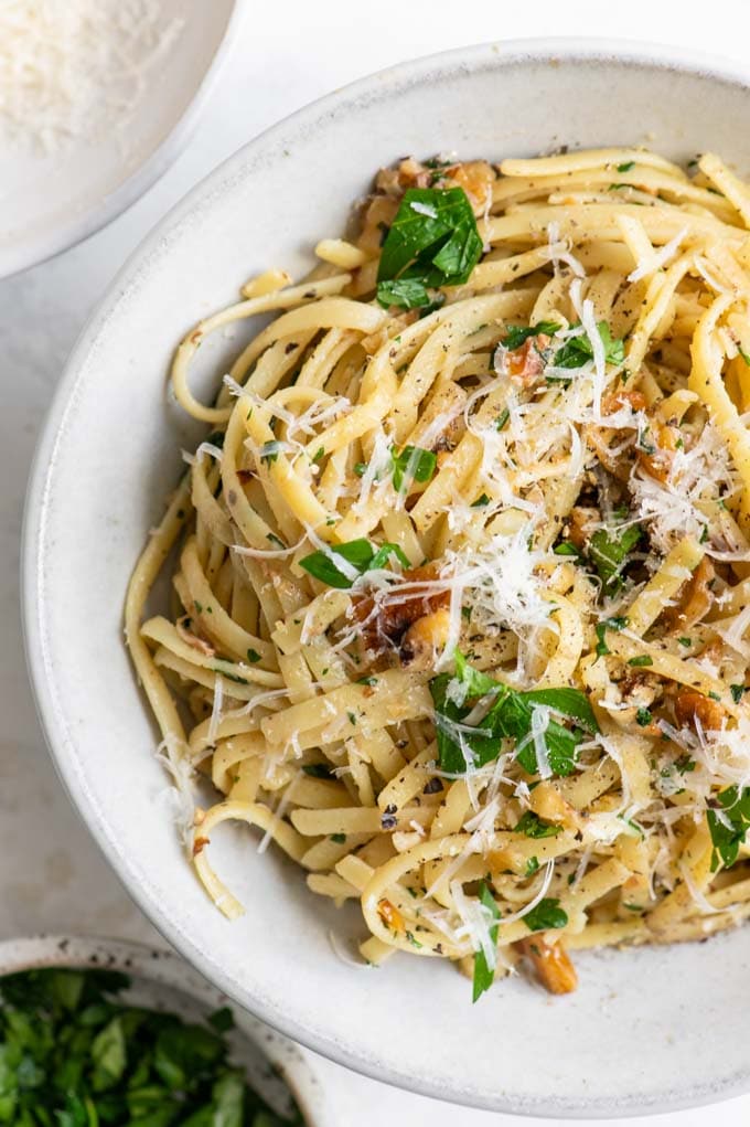 close up of walnut parsley linguine served in a bowl